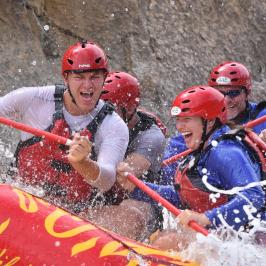 a group of people riding skis on a raft