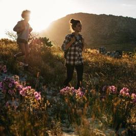 a group of people standing on top of a grass covered field