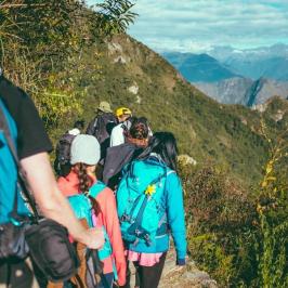 a group of people standing on top of a mountain